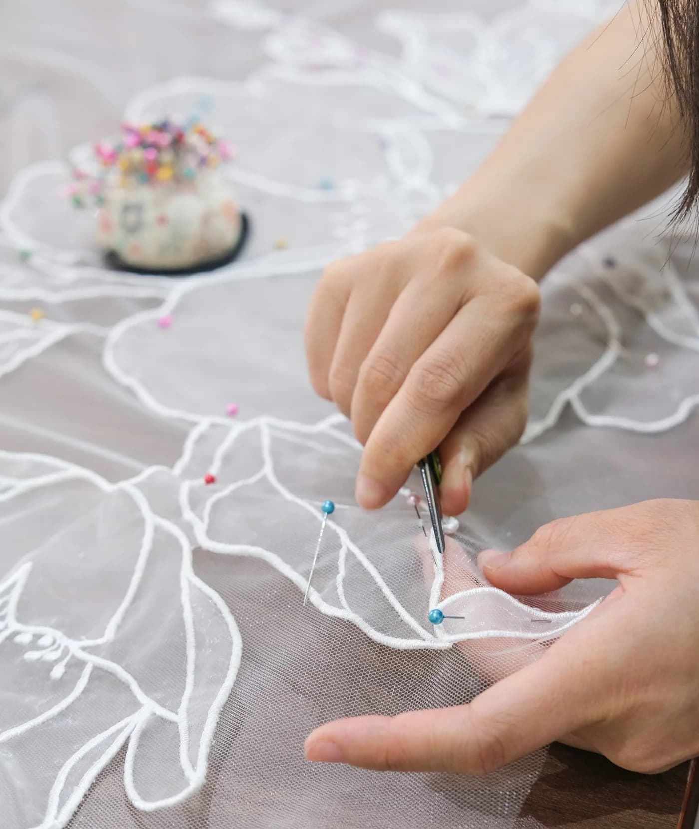 Tara Bridal artisan hand embroidering a veil
