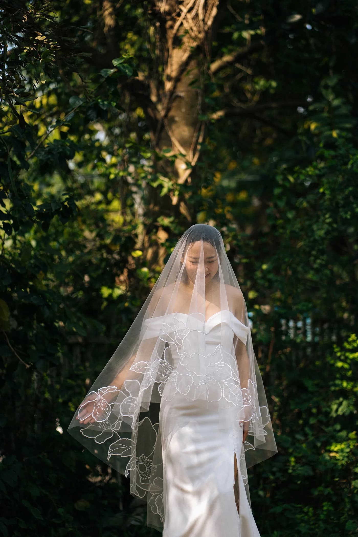 Bride wearing a Tara Bridal floral veil in a garden